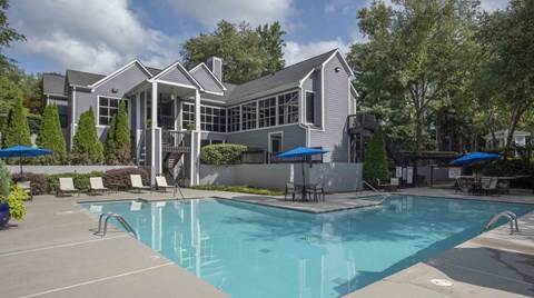 A large house with a pool in front.