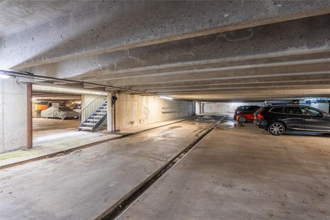 A car is parked in a dimly lit parking garage.