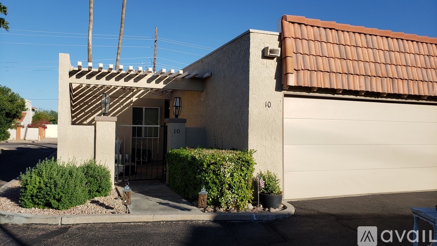 A house with a brown tiled roof and a white garage door.