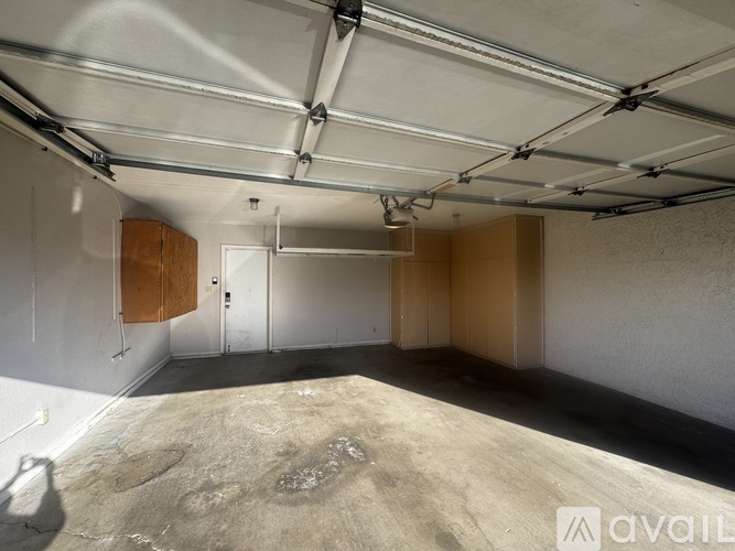 A spacious garage with a concrete floor and white walls.