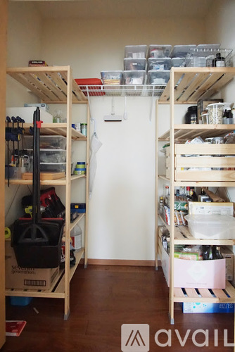 A small room with a lot of storage space and shelves.