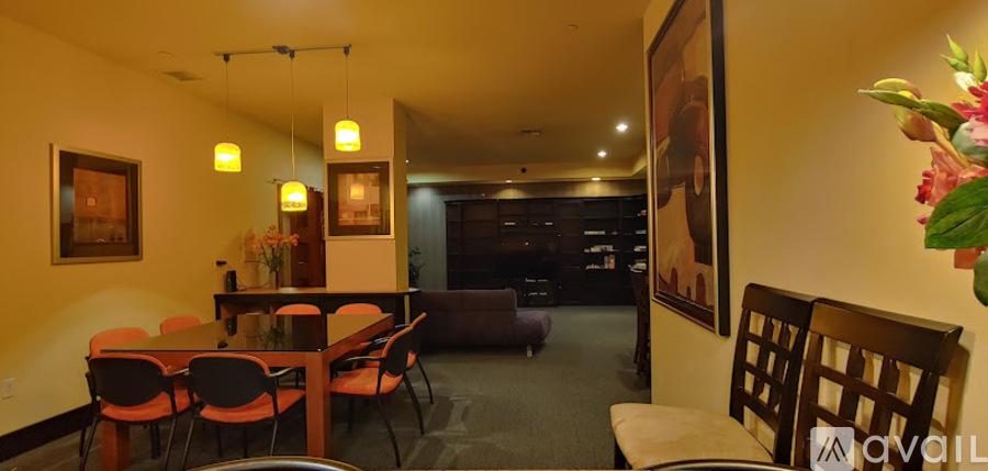 A dining room with a table set for six.