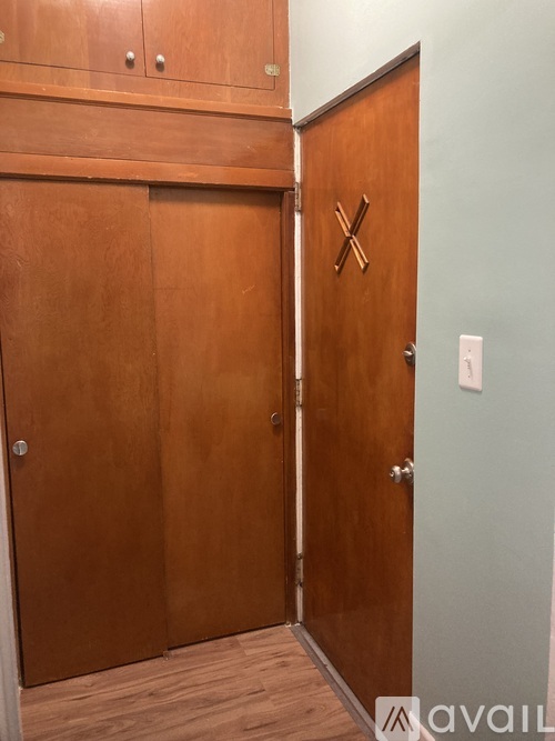A wooden door with a cross design on it.