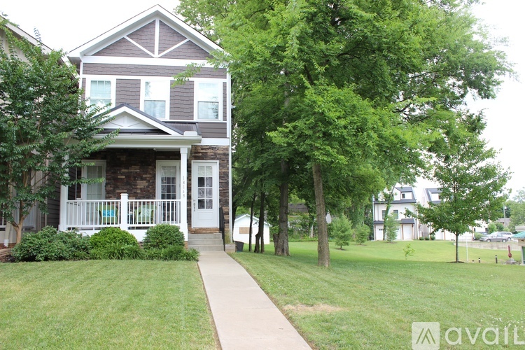 A house with a white door and a porch with a white railing.