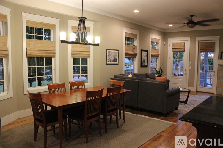 A dining room with a wooden table and chairs.