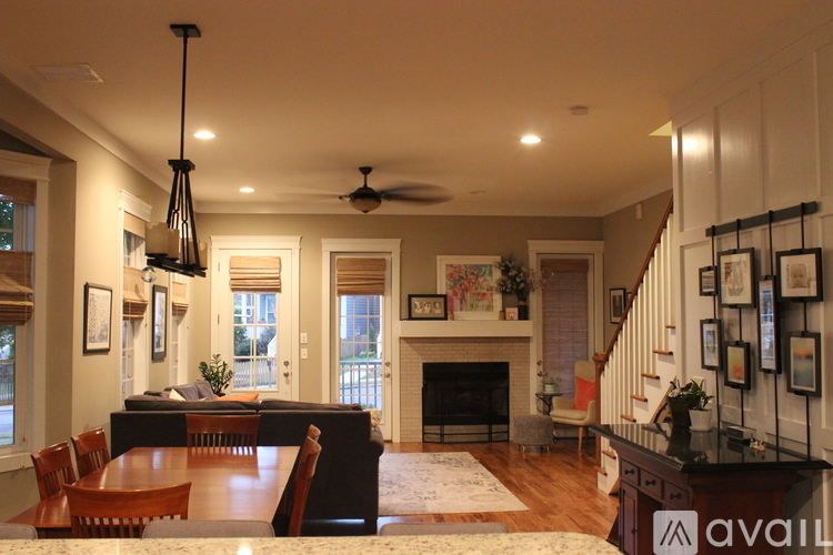 A living room with a fireplace and a dining table.
