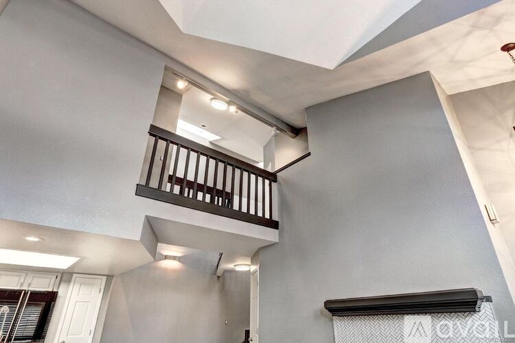 A balcony with a railing is on the second floor of a building.