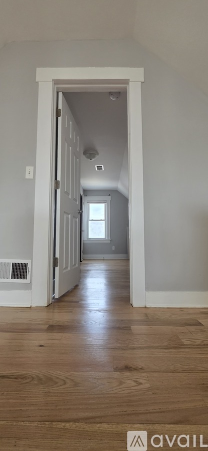A long hallway with a doorway at the end.