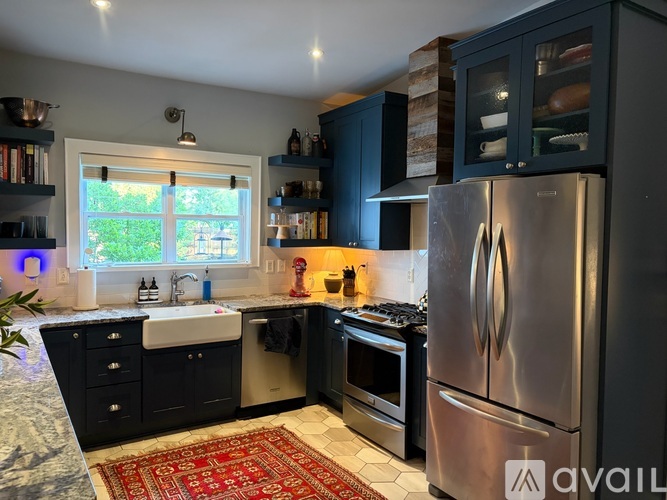 A kitchen with a refrigerator, sink, and oven.