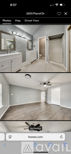 A bathroom with a sink, mirror, and a shower.