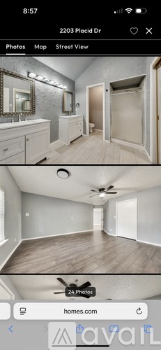 A bathroom with a sink, mirror, and a shower.
