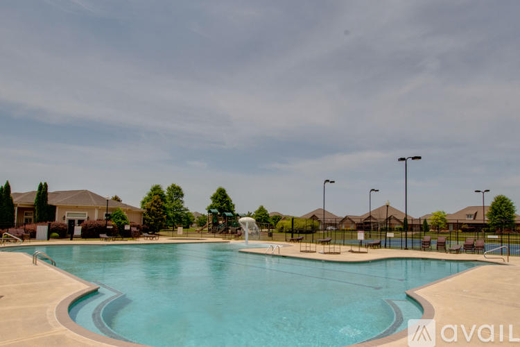 A large swimming pool with a fountain in the middle of it.