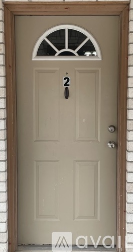 A beige door with a number 2 on it.