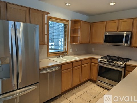 A kitchen with wooden cabinets and stainless steel appliances.