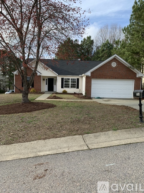 A house with a white garage door and a brown roof.