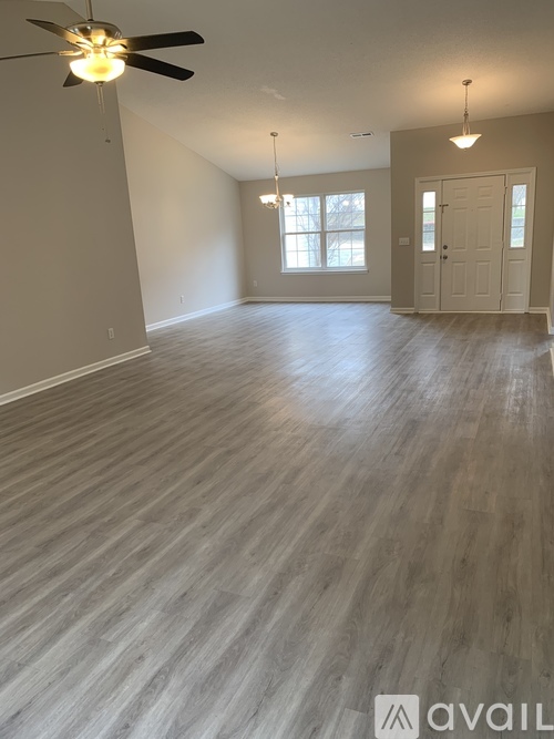 A room with a ceiling fan and lighting fixtures.
