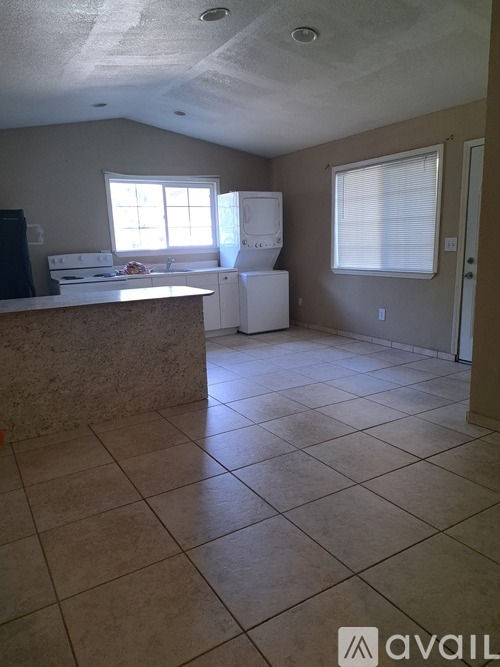 A kitchen with a white fridge and a counter top.