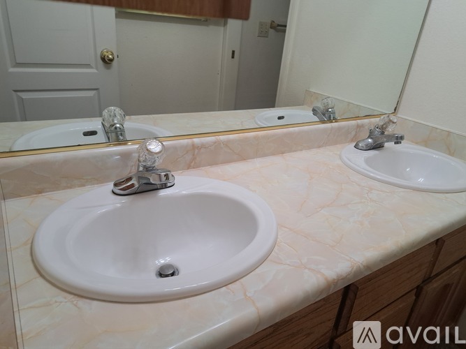 A bathroom with two sinks and a mirror.