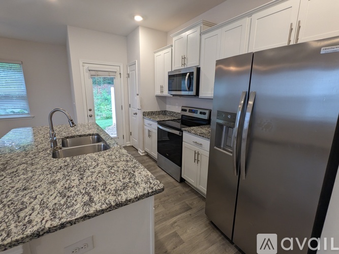 A kitchen with granite countertops and stainless steel appliances.