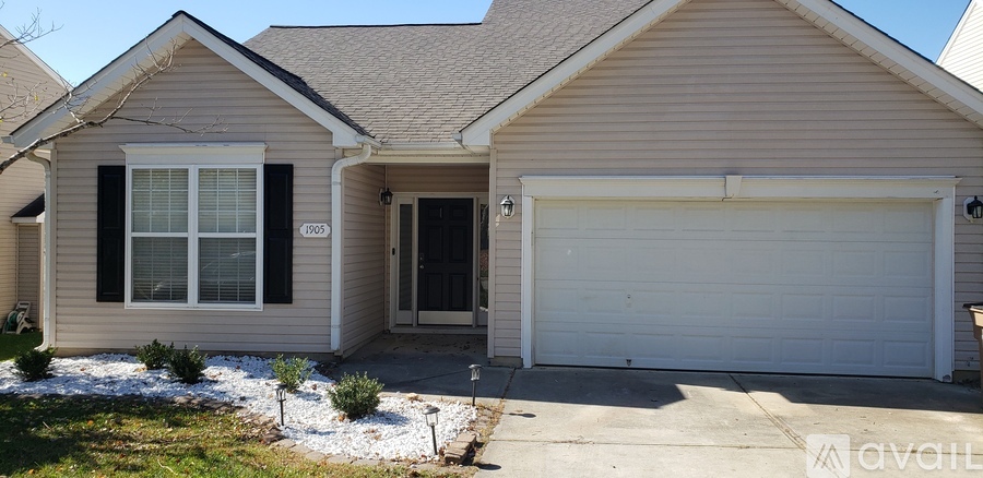 A house with a white garage door and a black door.