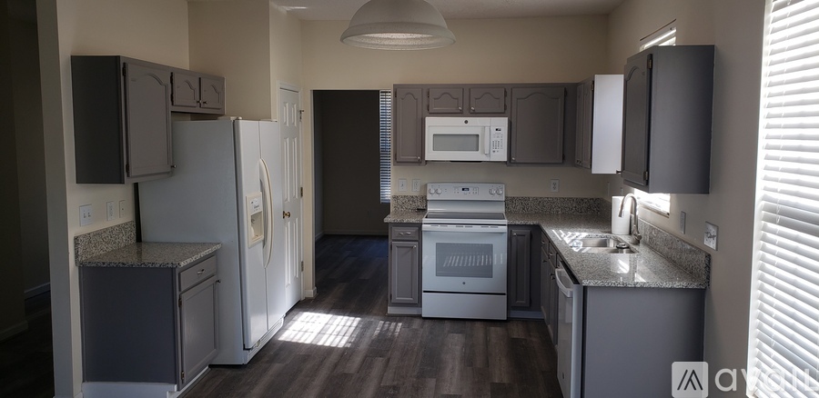 A kitchen with a white refrigerator and a white oven.