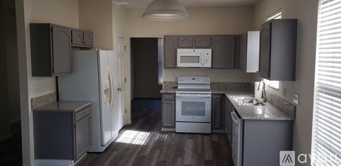 A kitchen with a white refrigerator and a white oven.