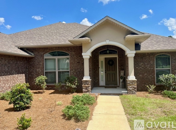 A house with a front yard and a walkway leading to the front door.