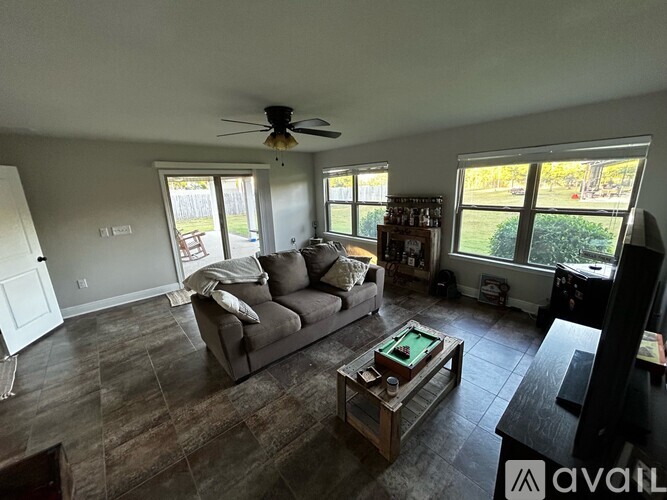A living room with a grey couch and a coffee table.