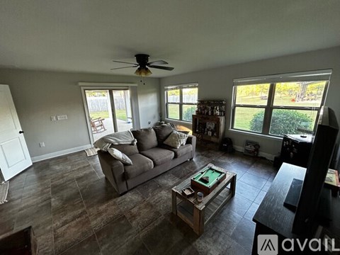 A living room with a grey couch and a coffee table.