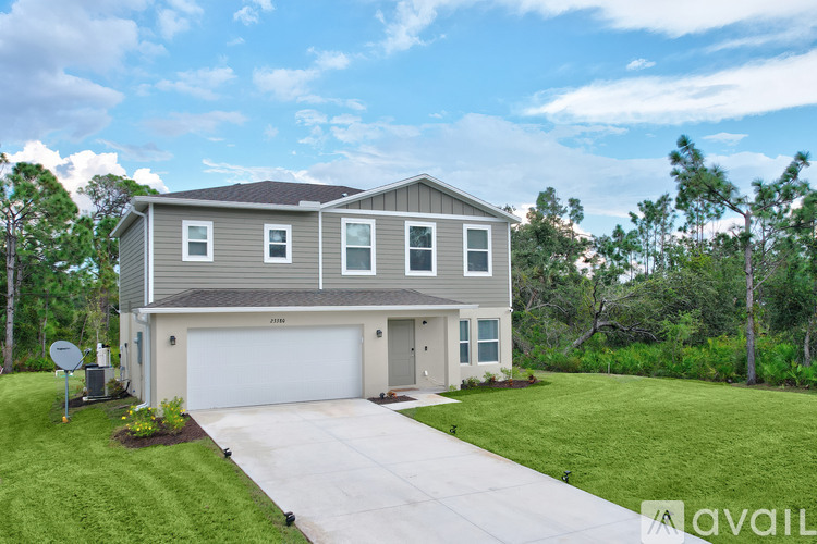 A two-story house with a garage is available for sale.
