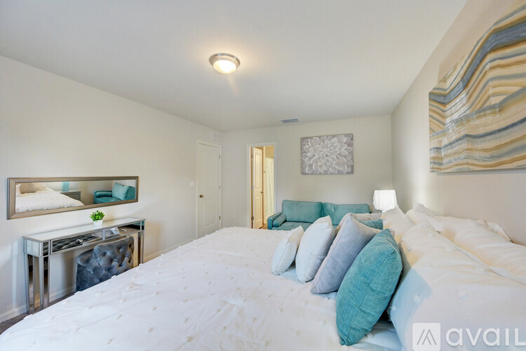 A bedroom with a large bed and a mirror on the wall.