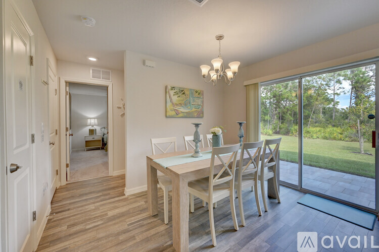 A dining room with a wooden table and chairs.