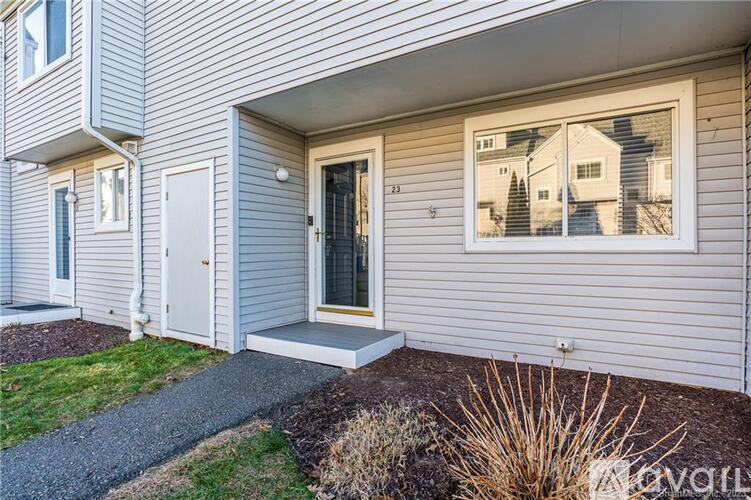 A house with a grey siding exterior and a white door.