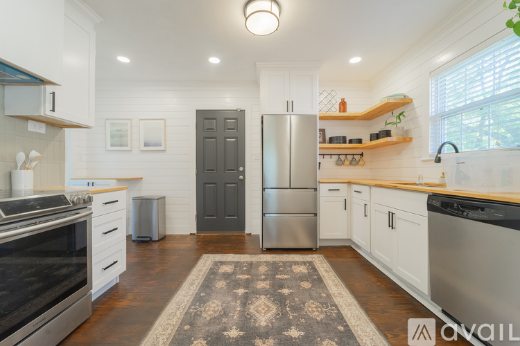 A kitchen with a refrigerator, stove, and oven.