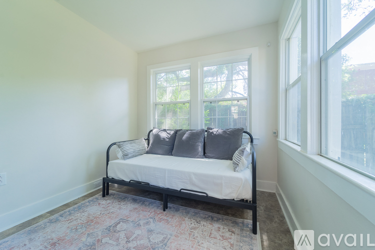 A bedroom with a bed and a window.