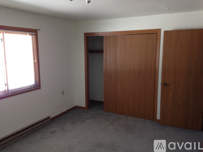 A room with a window, a door, and a wall.