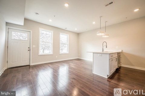 A kitchen area with a white cabinet and a sink.