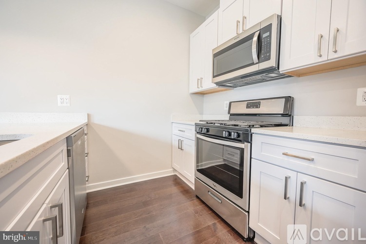 A kitchen with a stove, oven, and microwave.