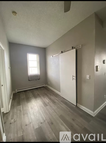 A room with a window and a white door.