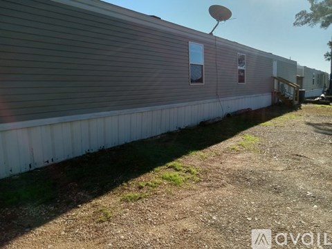 A mobile home with a satellite dish on the roof.