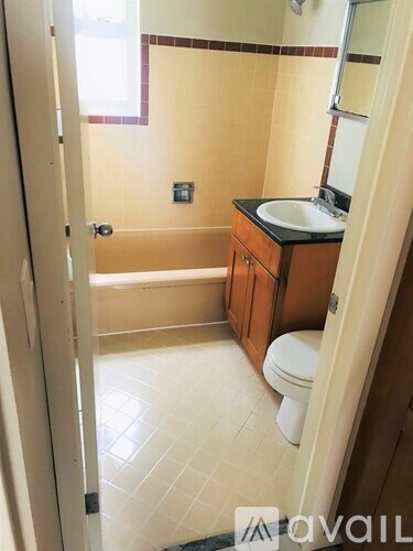 A bathroom with a toilet, sink and bathtub.