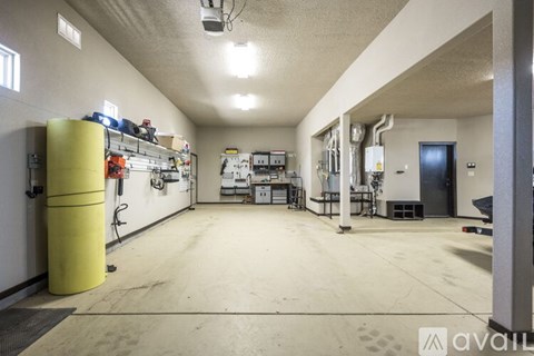 A large, empty industrial space with a yellow cylindrical object on the left side.