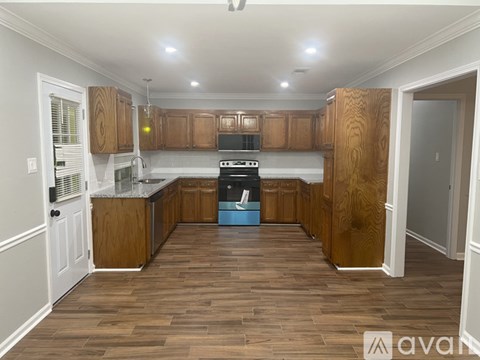 A kitchen with wooden cabinets and a blue dishwasher.