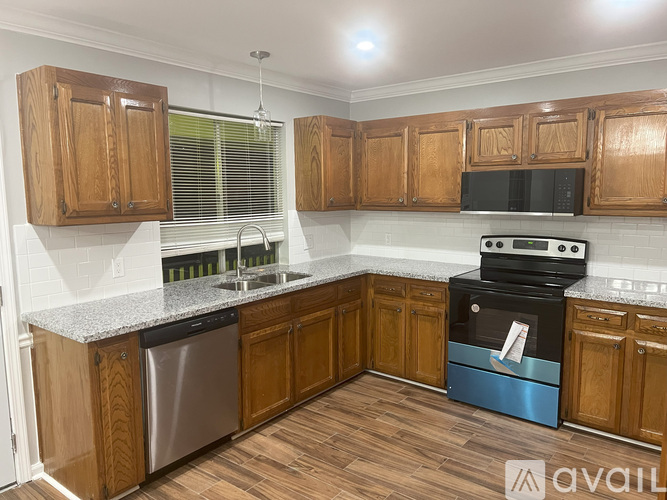 A kitchen with wooden cabinets and a blue oven.