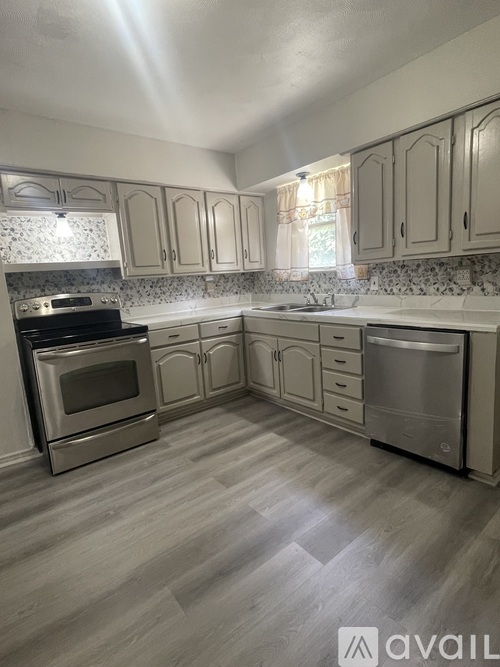 A kitchen with a stove, oven, and dishwasher.