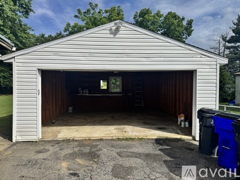 A garage with a white exterior and brown interior is shown.