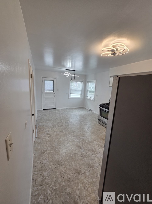 A room with a carpeted floor and a ceiling light.