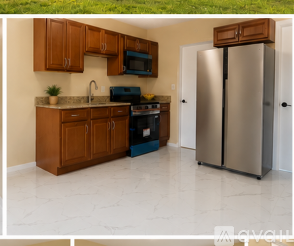 A kitchen with a refrigerator, microwave, and oven.