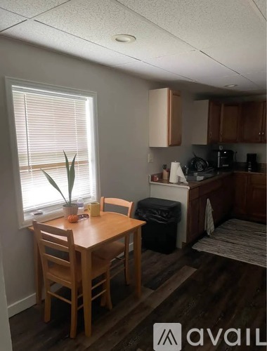 A kitchen with a table and chairs by the window.
