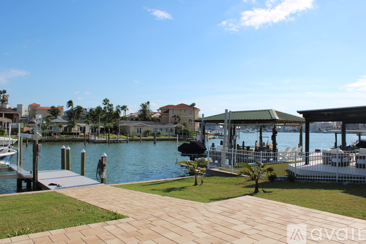 A dock with a boat and a building in the background.
